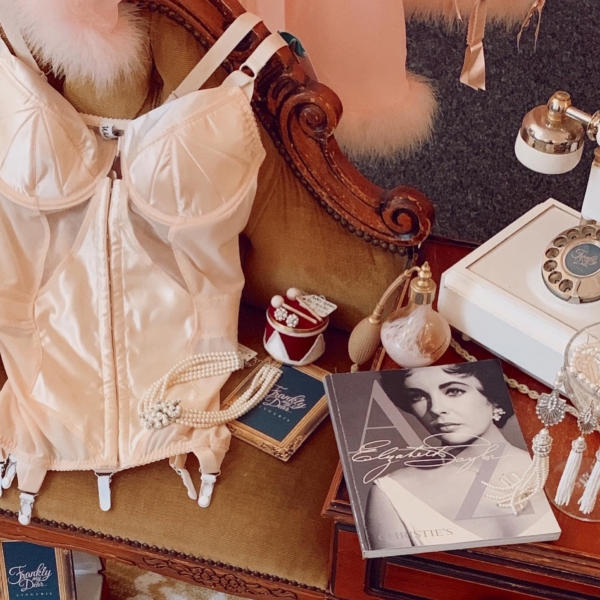 What Katie Did Peach corselette on vintage style telephone table with vintage telephone and Elizabeth Taylor book