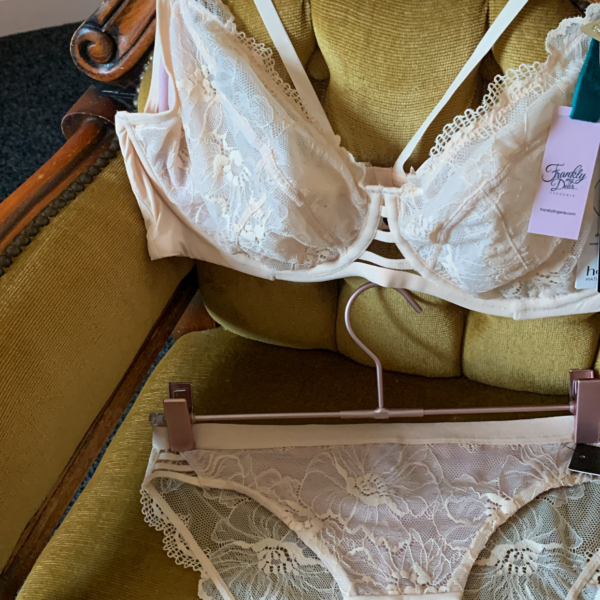 Ivory lace maternity bra and briefs placed on vintage telephone seat